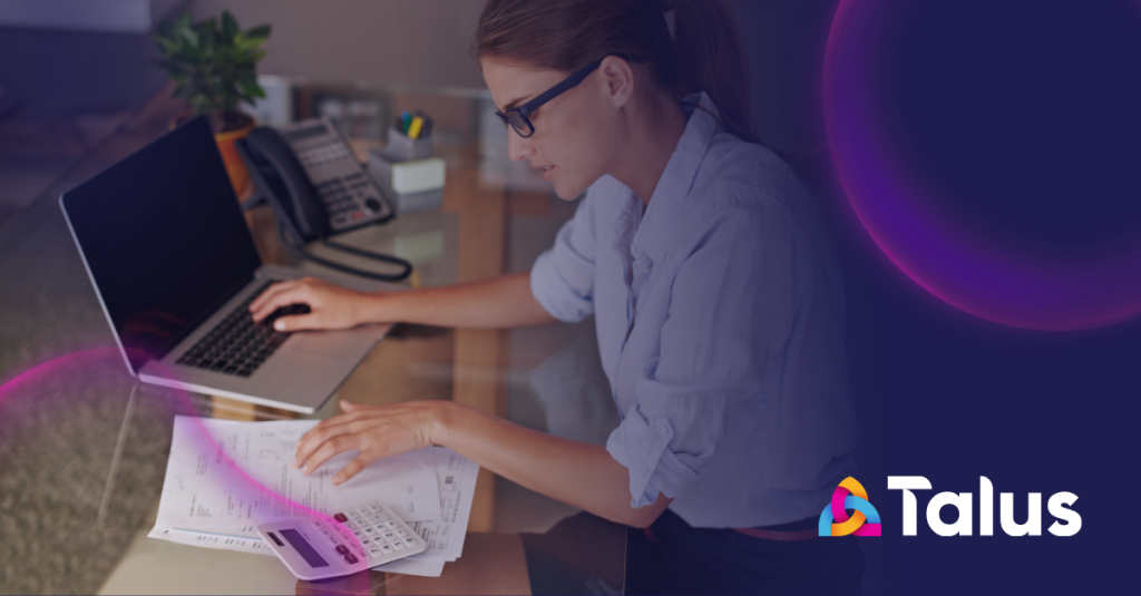Finance professional managing multiple HealthComms specialist invoices at a desk.